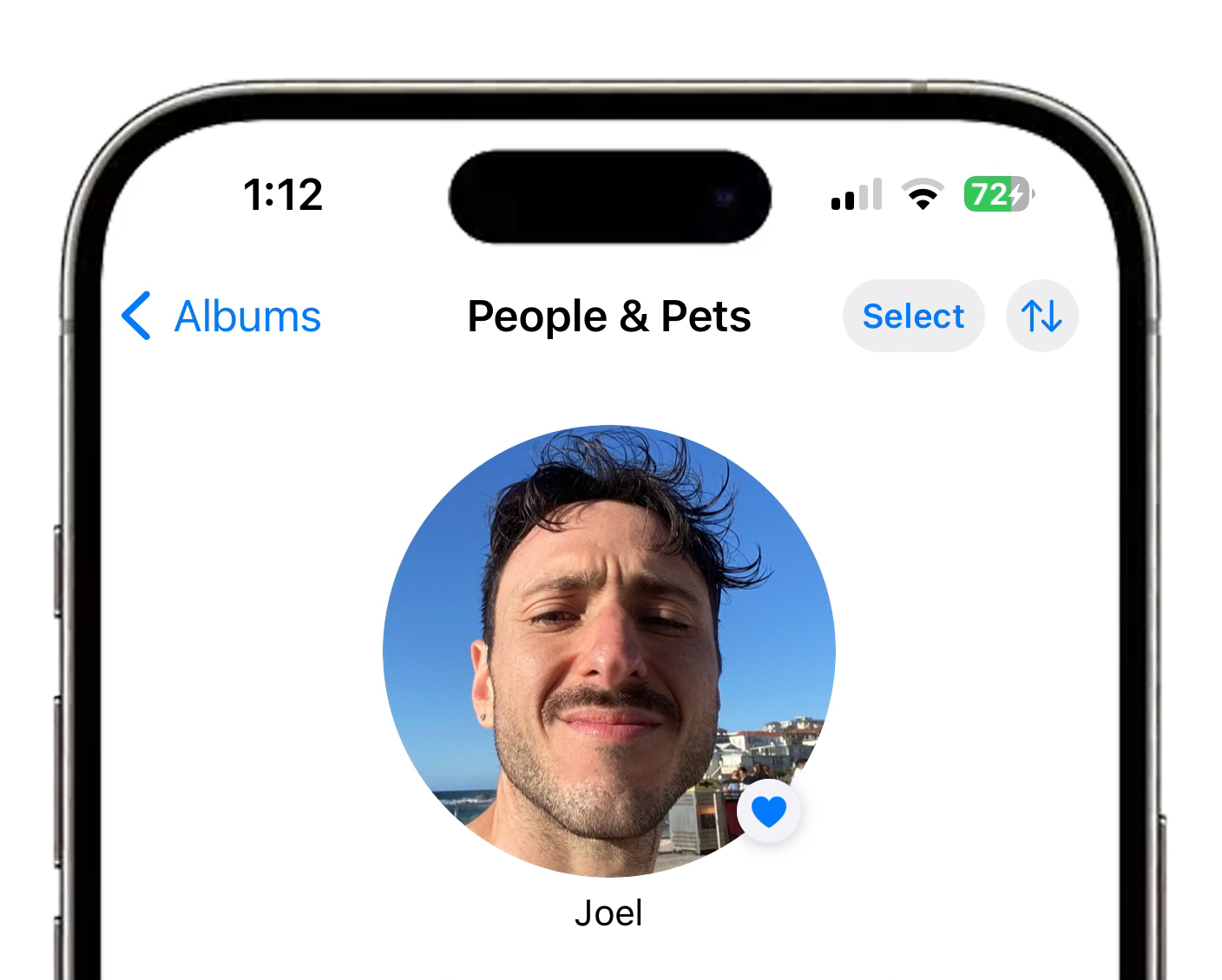 Screenshot of a smartphone interface showing a 'People & Pets' photo album. In the center is a highlighted circular thumbnail labeled 'Joel' featuring a smiling person with short brown hair and a slight stubble, against a clear blue sky backdrop.