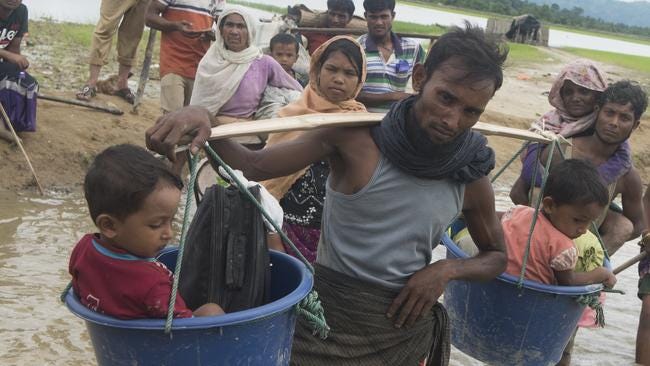 Rohingya people bringing their children in buckets at Palong Khali Border. Picture: Parvez Ahmad Rony