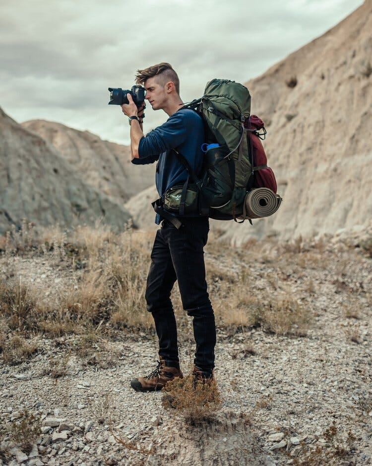 Photo of Alex Haraus with a camera and a backpack