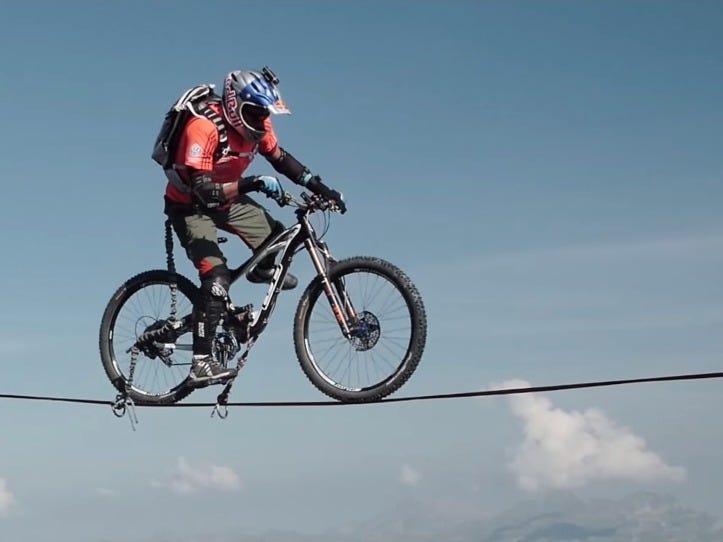 Man Rides a Bike Over a Tightrope Between the French Alps