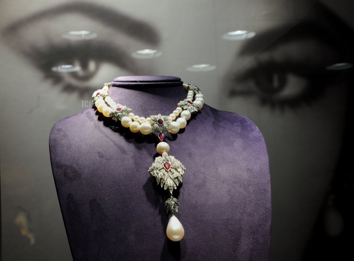 La Peregrina is suspended from a Cartier pearl, diamond and ruby necklace, owned by US actress Elizabeth Taylor, during an auction preview on December 1, 2011 at Christie's in New York (STAN HONDA/AFP via Getty Images)