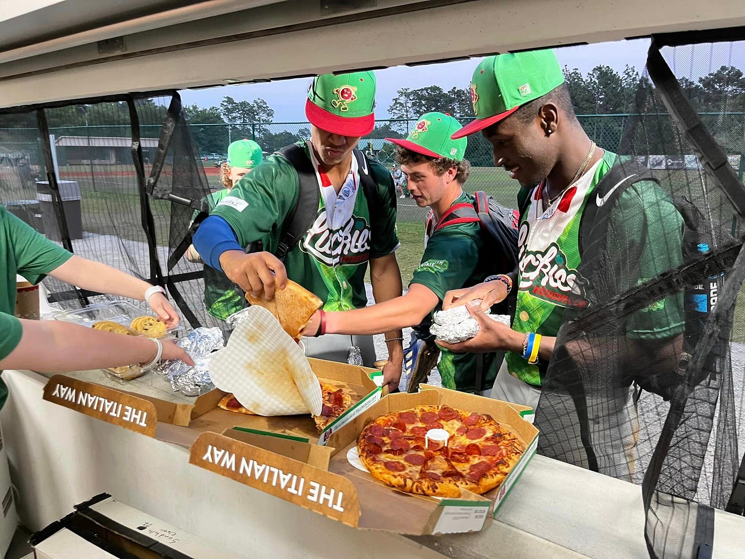 May be an image of 5 people, pizza and text