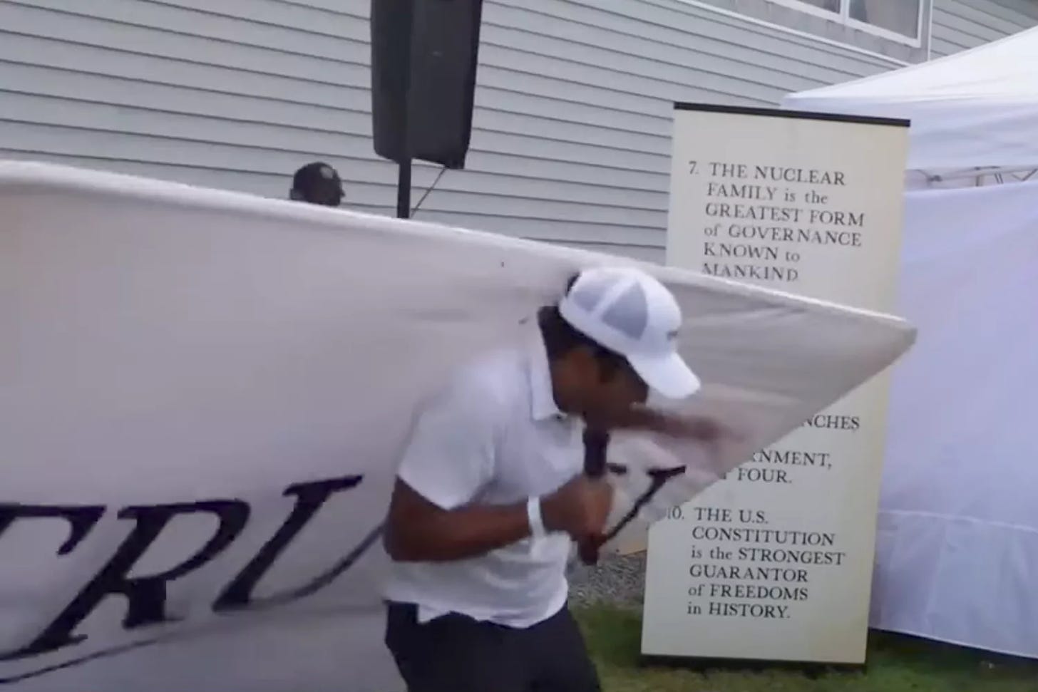 Vivek Ramaswamy's Campaign Speech Was Briefly Interrupted When a Sign Reading "Truth" Fell on Him
