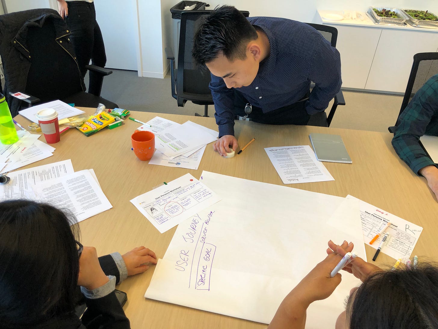 A close-up of a workshop participant working at the table