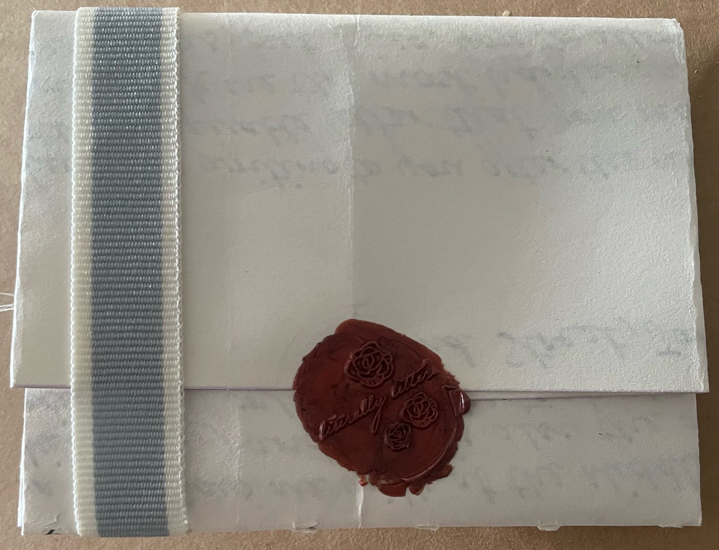 Unopened letter turned over to see its seal on the back.