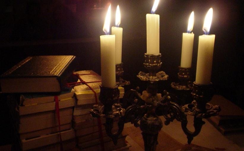 A group of candles in a candle holder

AI-generated content may be incorrect.