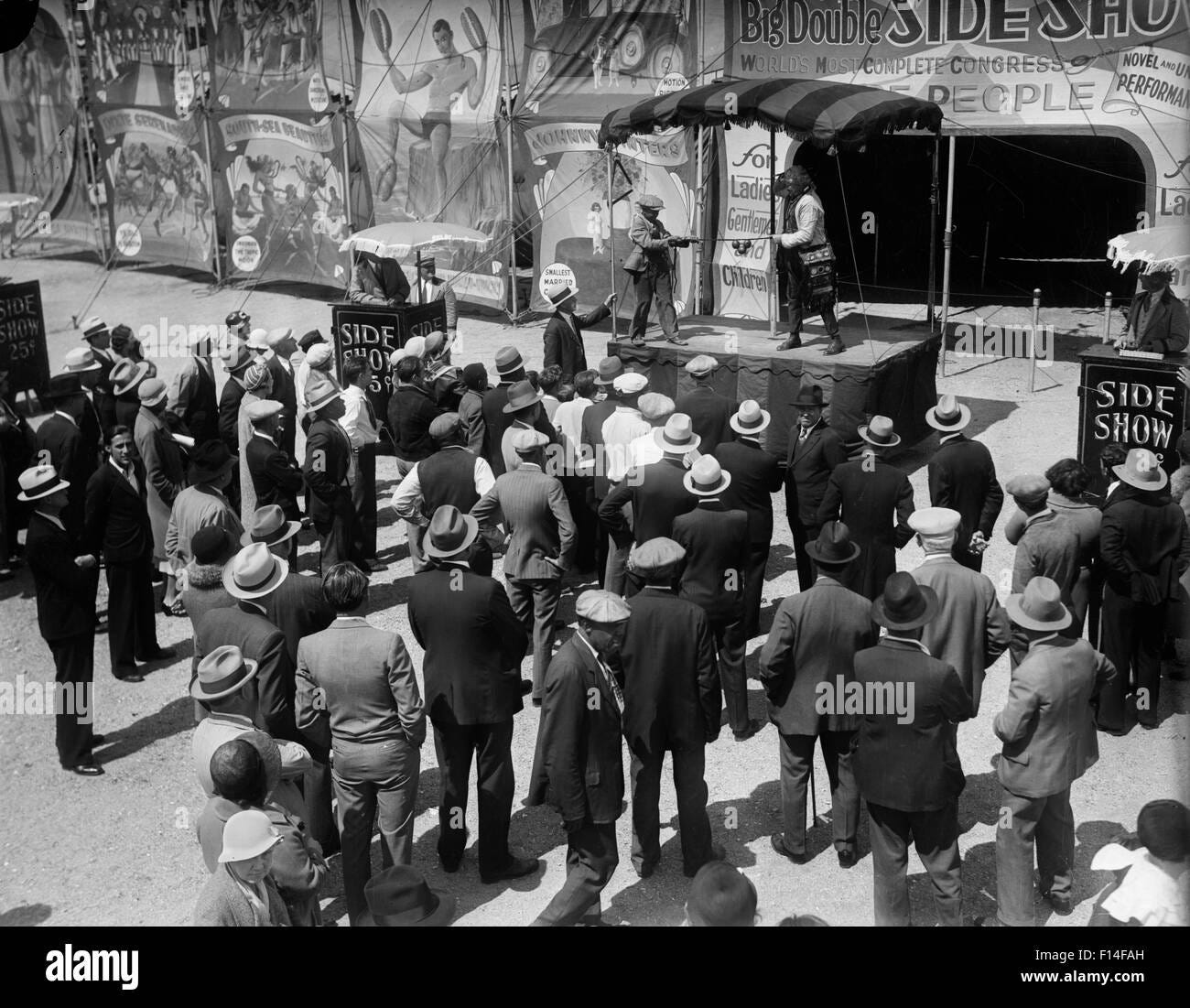 1930s-crowd-watching-circus-side-show-act-F14FAH.jpeg