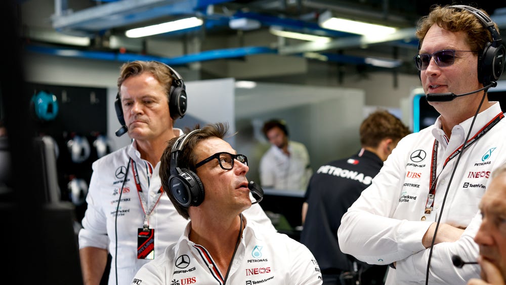Toto Wolff, team principal of the Mercedes-AMG Petronas Formula One team (center) and Ola Källenius, global CEO of Mercedes-Benz (standing to the right) during a race weekend.
