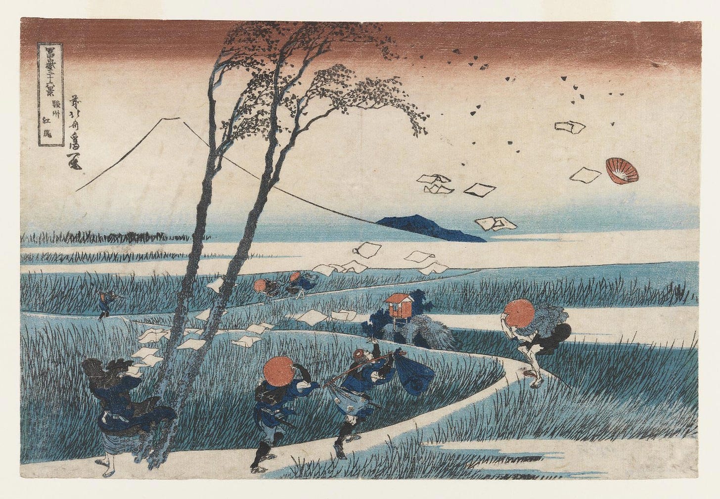 An Ukiyo-e print by Japanese artist Hokusai, depicting several people overcome by a gust of wind. A tall tree bends in the foreground, one of the figures was holding a sheaf of papers which are now airborne, others are holding their hats. All are walking down a path in a grassy marsh. In the far background is an outline of Mount Fuji.