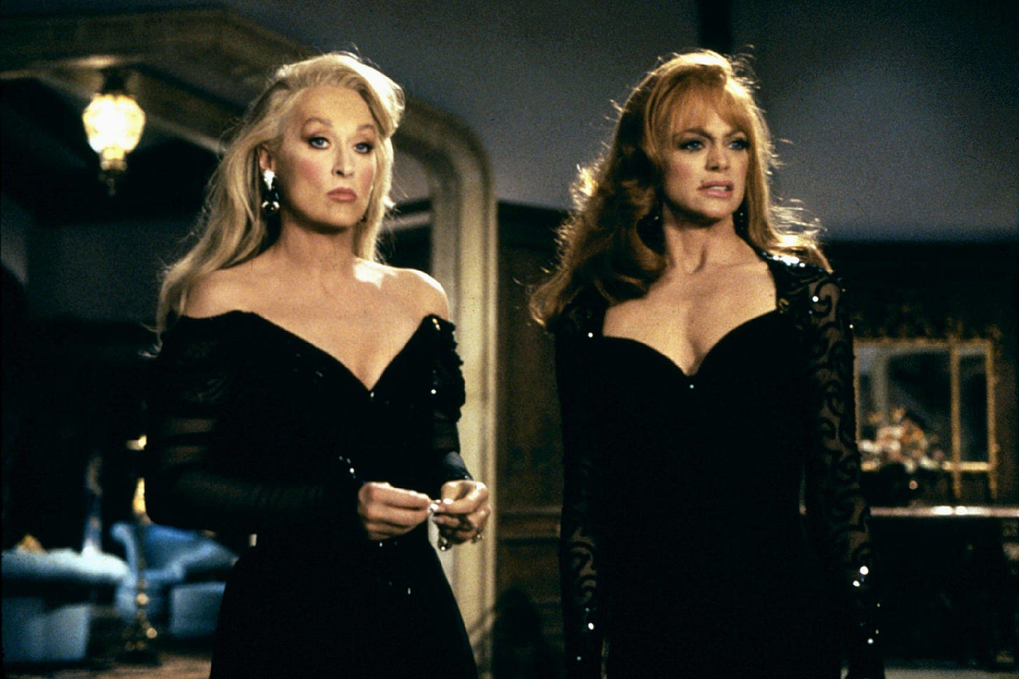 Meryl Streep and Goldie Hawn standing next to each other, both wearing black dresses