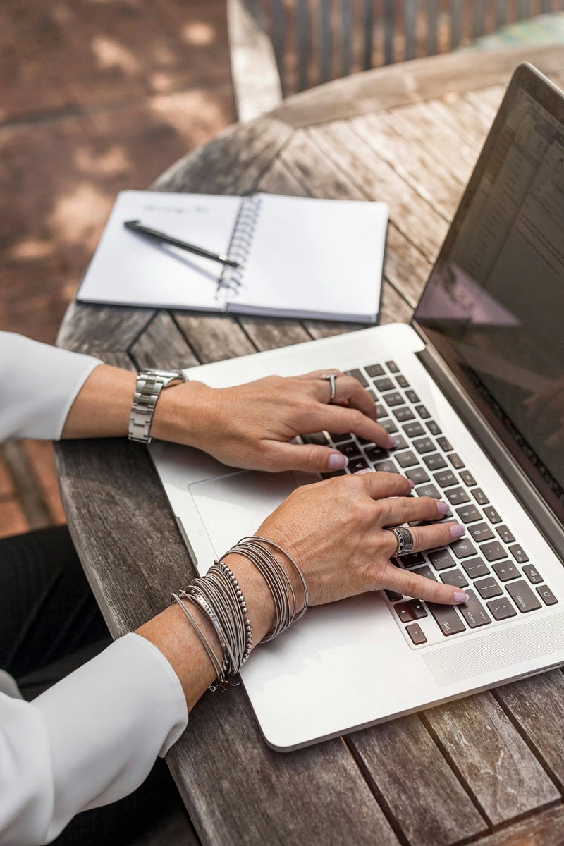 Person typing on laptop Person typing on laptop