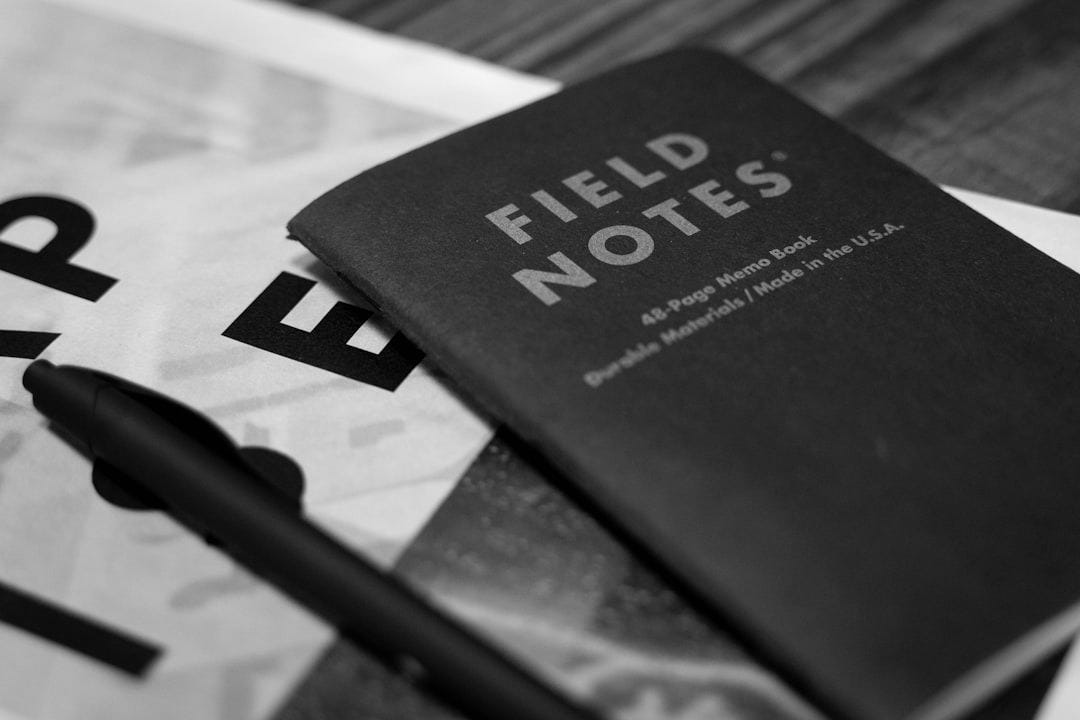 a book with a pen sitting on top of it a book with a pen sitting on top of it