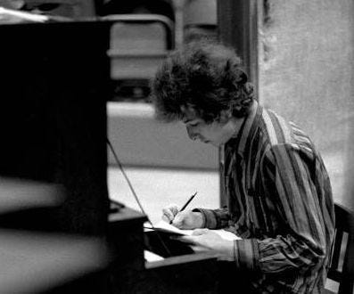 Bob Dylan writing a song at a piano