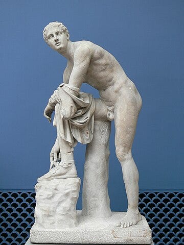 Hermes fastening his sandals. Roman copy (2nd century AD) of a Greek original (4th century BC). 