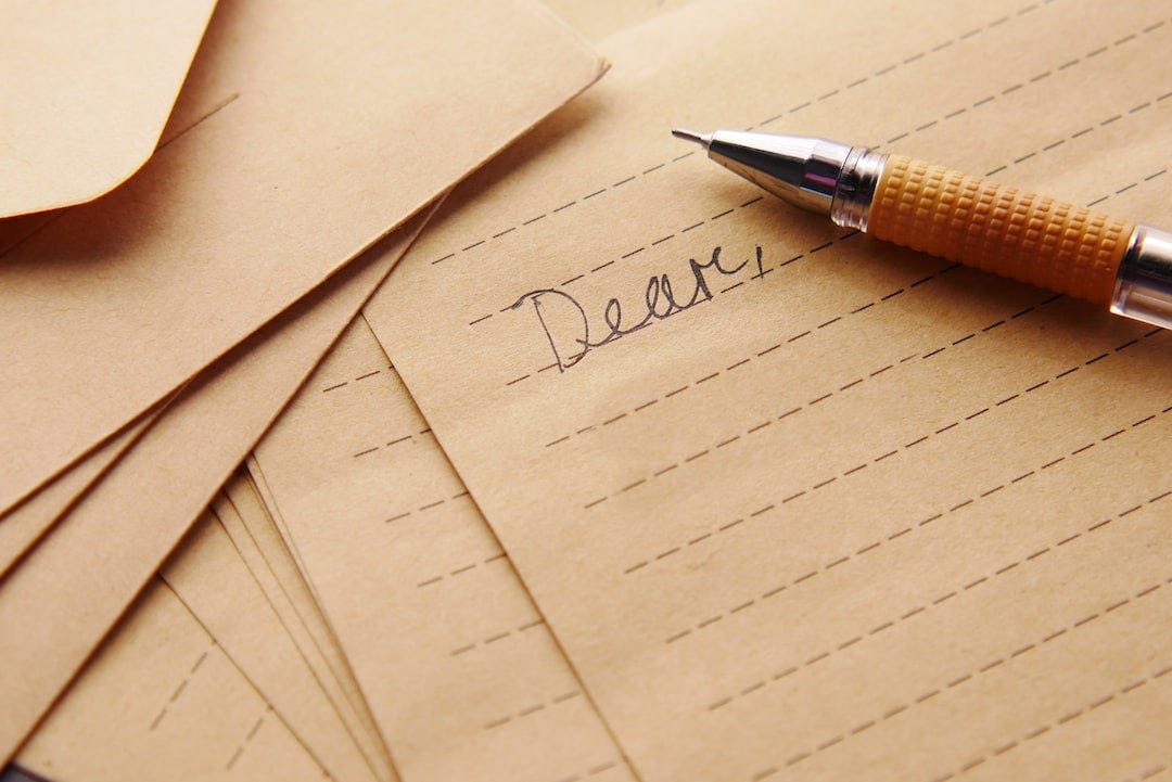 a pen sitting on top of a piece of paper a pen sitting on top of a piece of paper