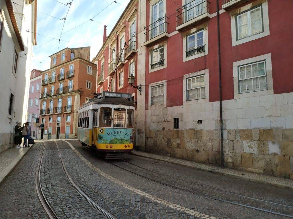 A tram rattling through the streets of Lisbon. Why do I travel? To ride as many rails as I can.