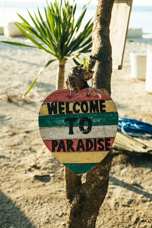 A sign that says, “WELCOME TO PARADISE”.