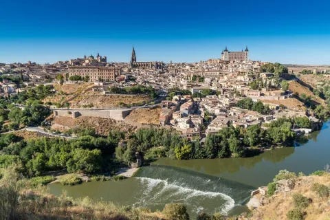 Toledo with a river and trees

Description automatically generated