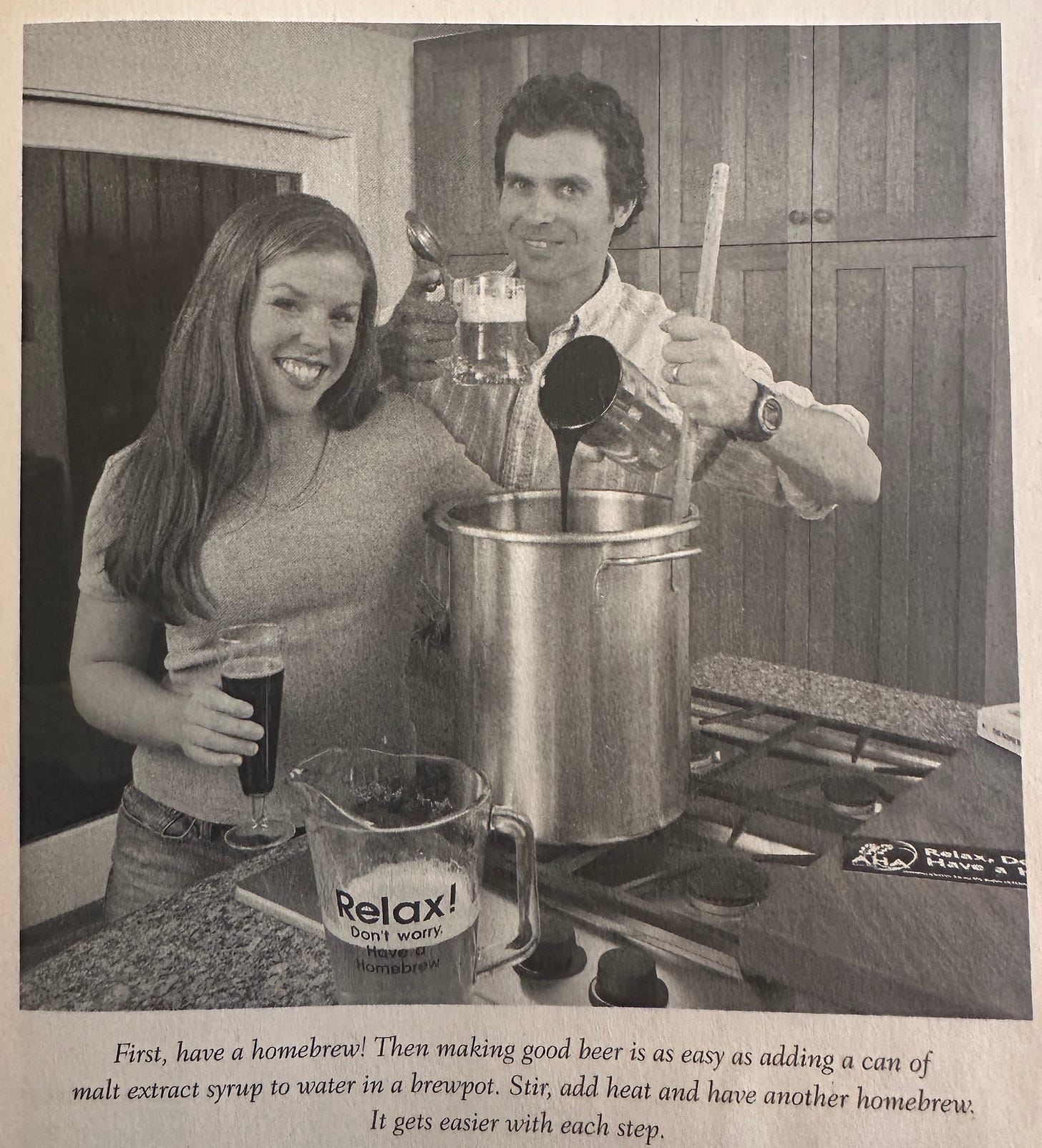 A man and woman in a kitchen brewing beer.