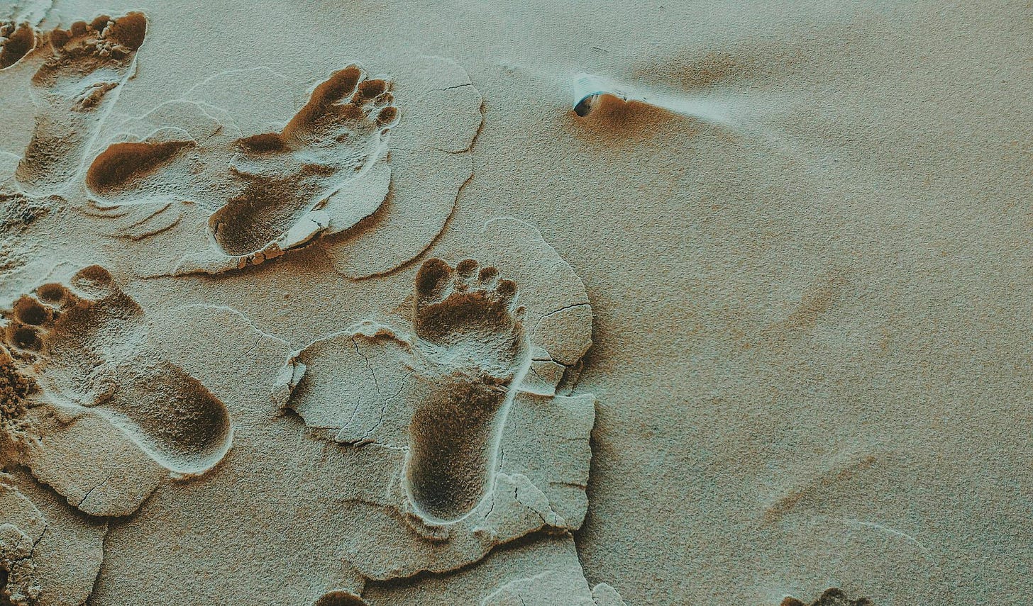 Footprints on the sand.