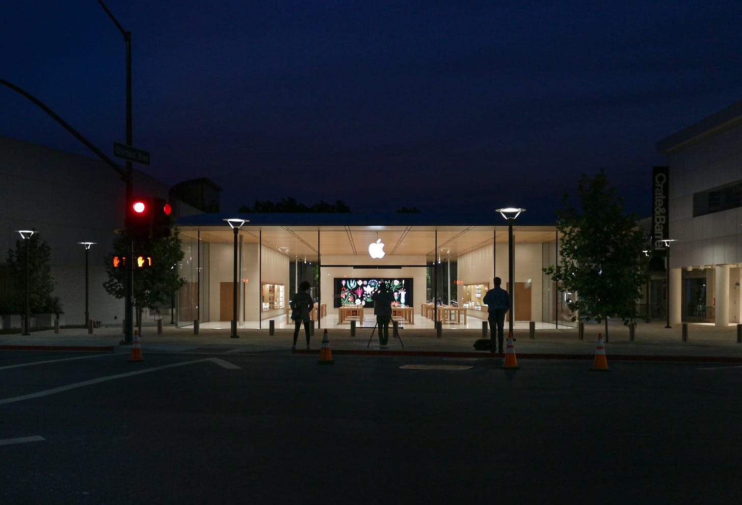 Just after 5:30 a.m. on July 28, 2018. A photographer is standing in front of Apple Broadway Plaza in the early morning light. The store's hero image is about to be captured. 