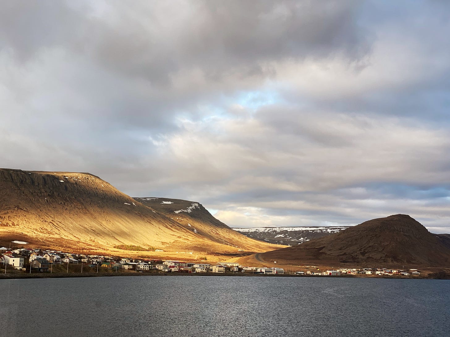 Golden hour sun on the hillsides across the fjord in Patreksfjordur.