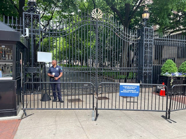 A person standing in front of a gate

Description automatically generated