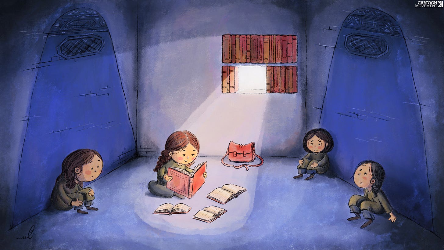 Cartoon showing three girls sitting on the ground. Two are in the dark, while the third one is reading a book in the light created by hole of a removed book in the window that has been boarded up using books. On the walls of the room we see painted burqas.