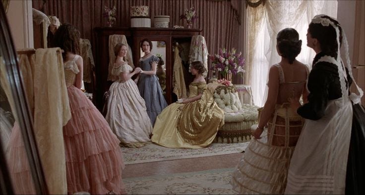This may contain: several women in dresses are looking at each other