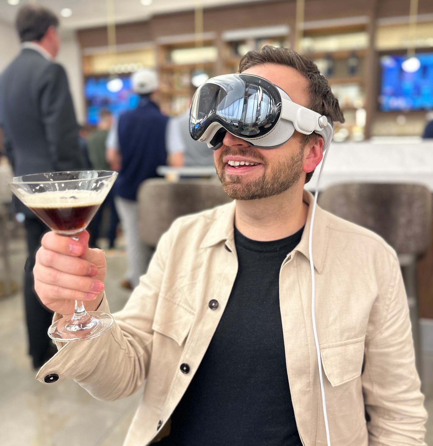 Matt Swider with Apple Vision Pro headset with a drink in hand