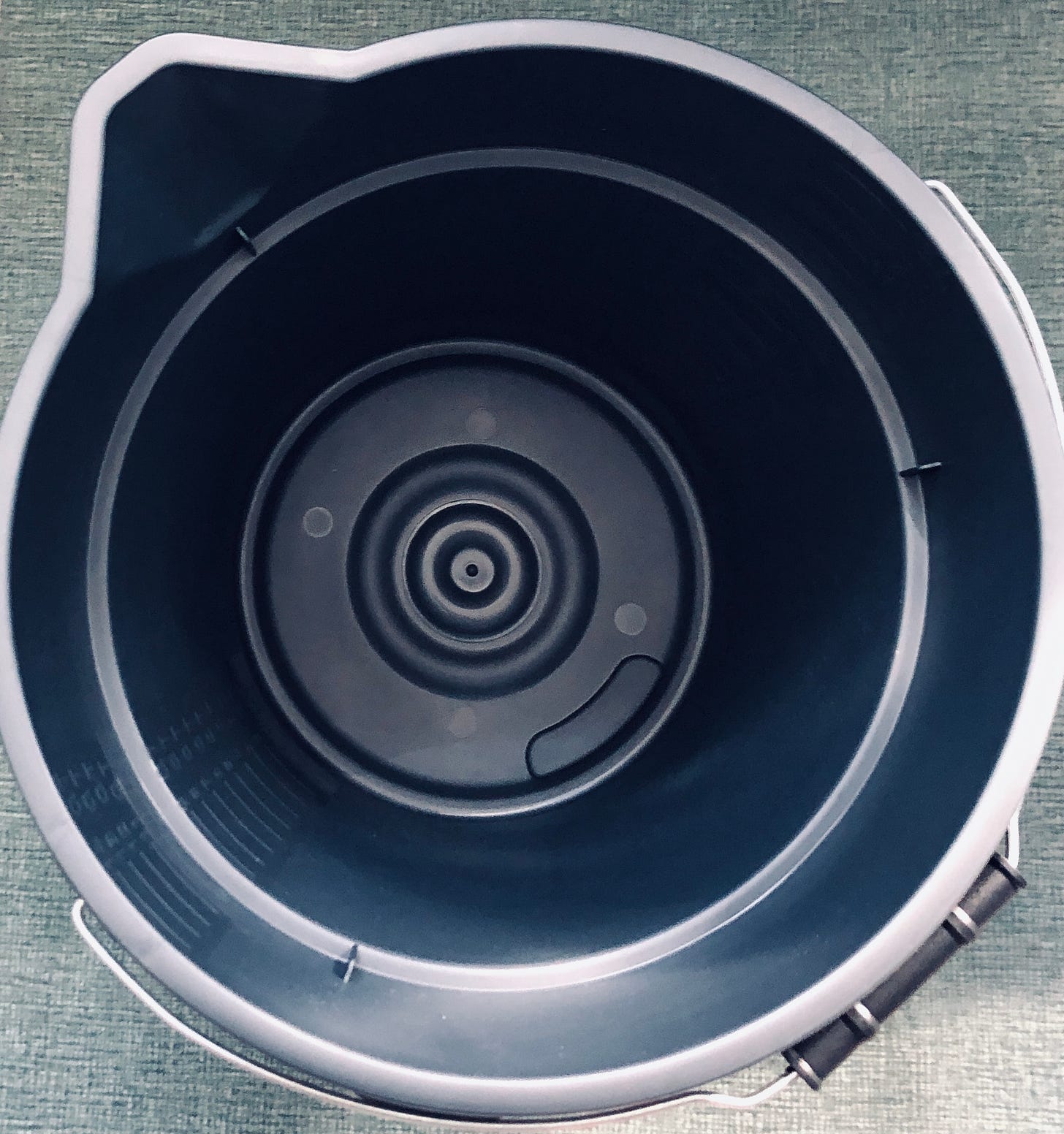 The inside of a black plastic bucket
