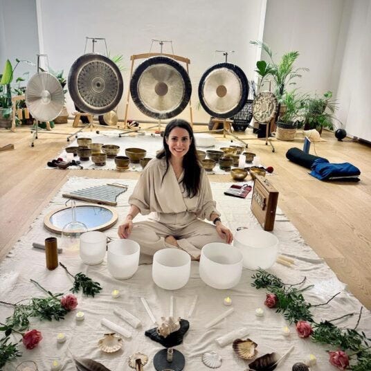 Sound healer sitting in front of gongs at Centre Element in Paris, France