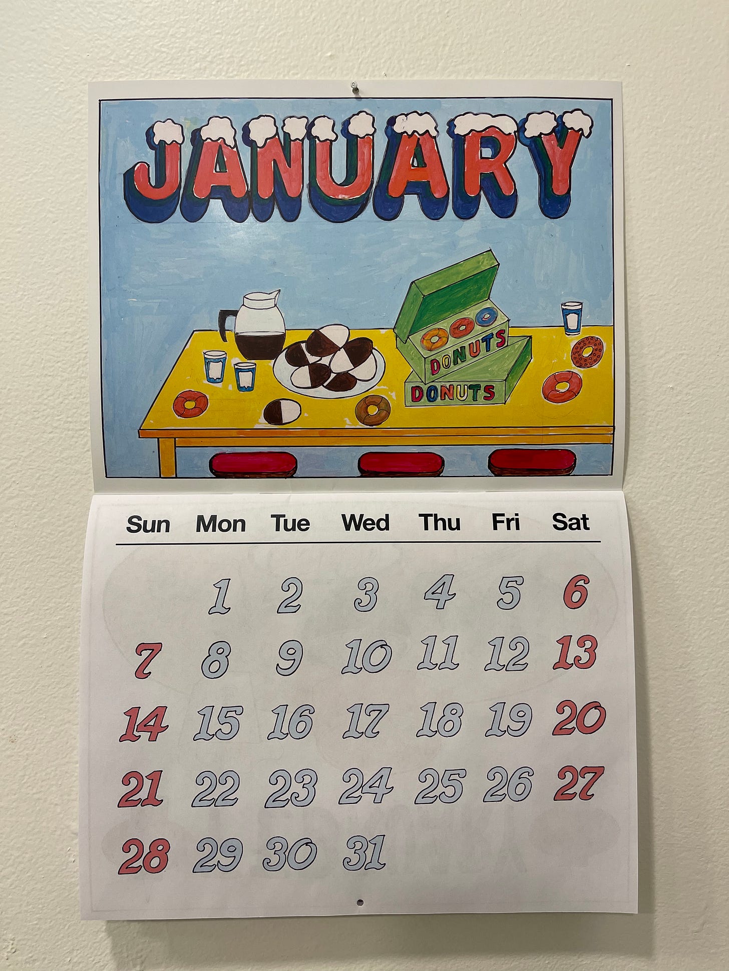 Wall calendar open to January 2024 will fun illustrations by the Cevallos Brothers