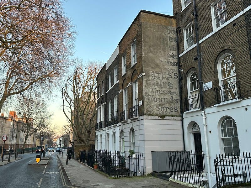 a ghost sign in regent square. until recently the roadway also featured a superfluous checkpoint barrier. i don't know why it was there or where it might have gone