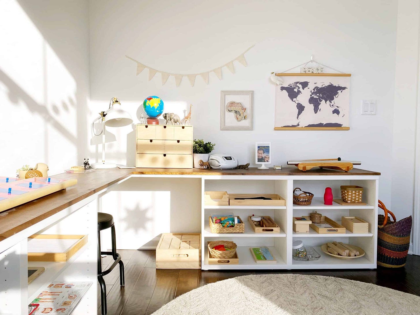 A muted and organized room with shelves of educational materials arranged for a child to access.