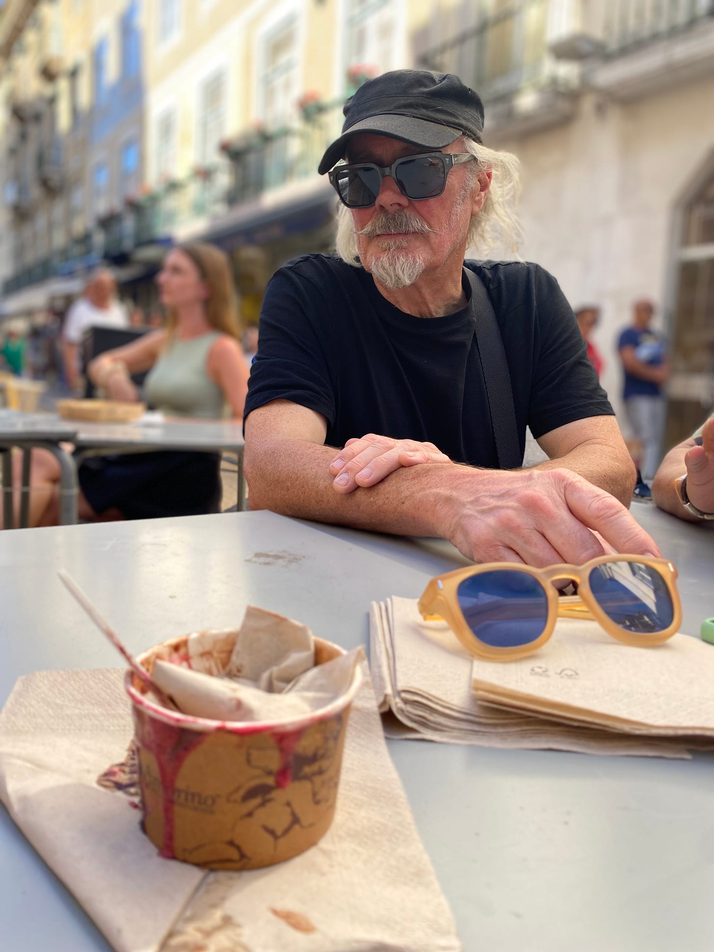 Simon Campbell in Lisbon and an empty icecream tub and sunglasses on the table