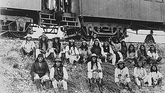 In this 1886 file photo, Apaches are en route to their imprisonment in Florida. Geronimo is third from right in front row.