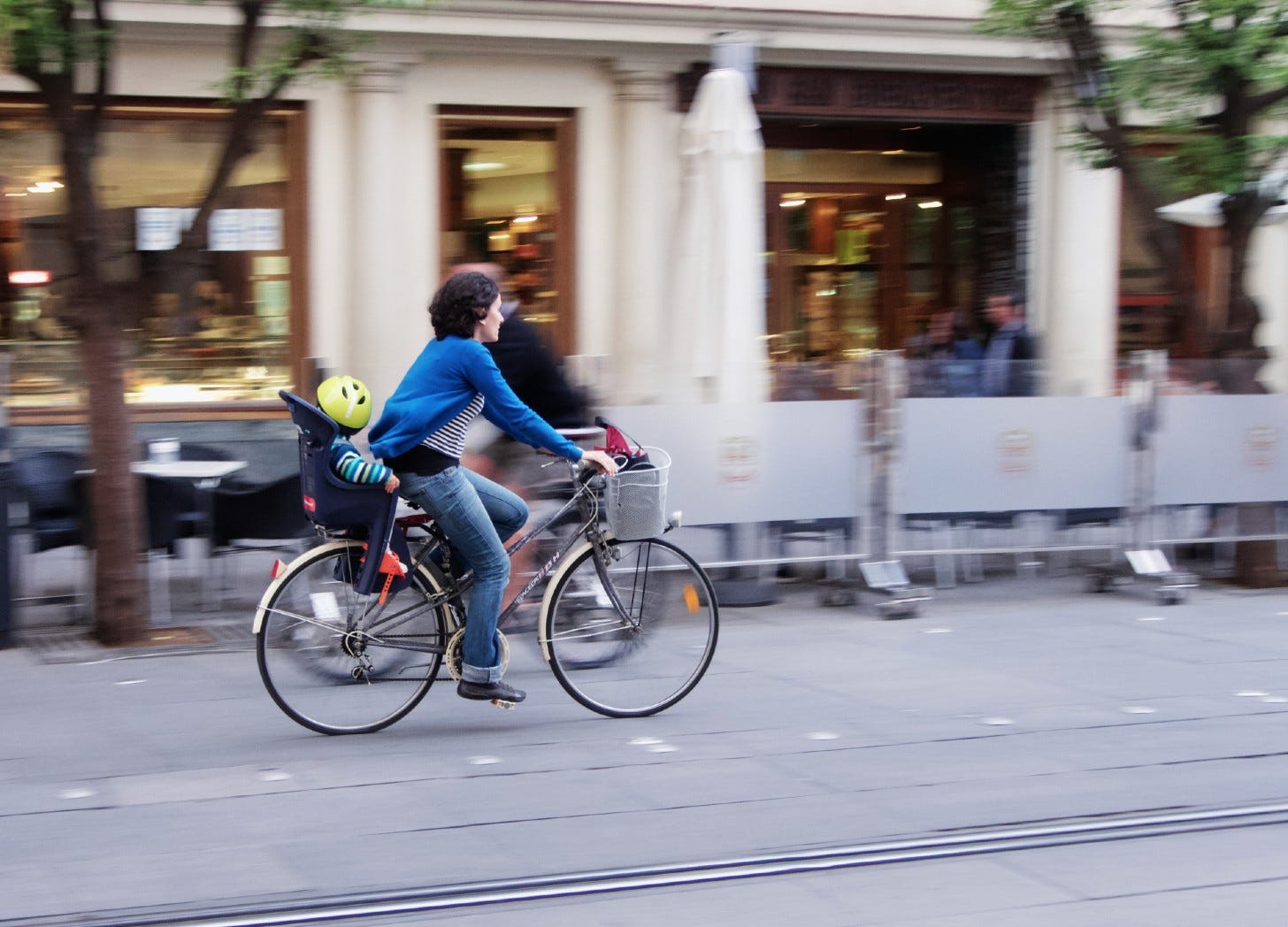 woman cycling through a city 