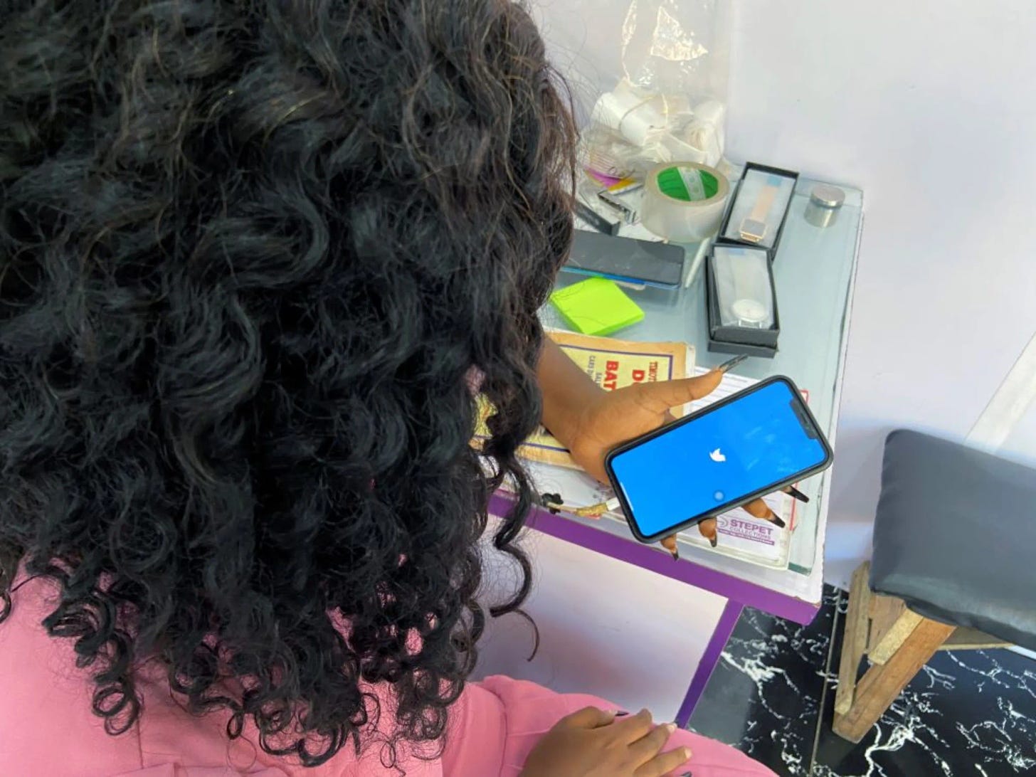 A women opens the Twitter app on a smart phone at her office in Lagos, Nigeria June 10, 2021