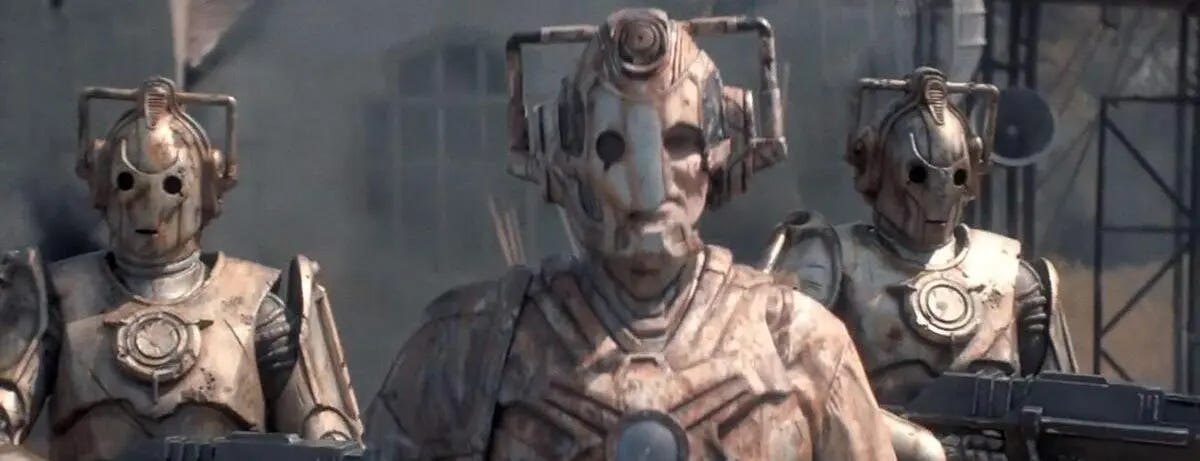 This image shows the "Lone Cyberman" known as Ashad (played by Patrick O'Kane,center) flanked by two fellow Cybermen in "Ascension of the Cybermen" (Doctor Who Series 12's ninth episode). This image shows the "Lone Cyberman" known as Ashad (played by Patrick O'Kane,center) flanked by two fellow Cybermen in "Ascension of the Cybermen" (Doctor Who Series 12's ninth episode).