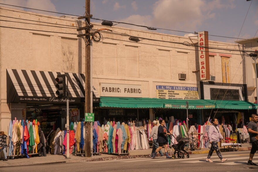 Samples of fabric spill out from storefronts onto the sidewalks of Downtown L.A.'s Fashion District.