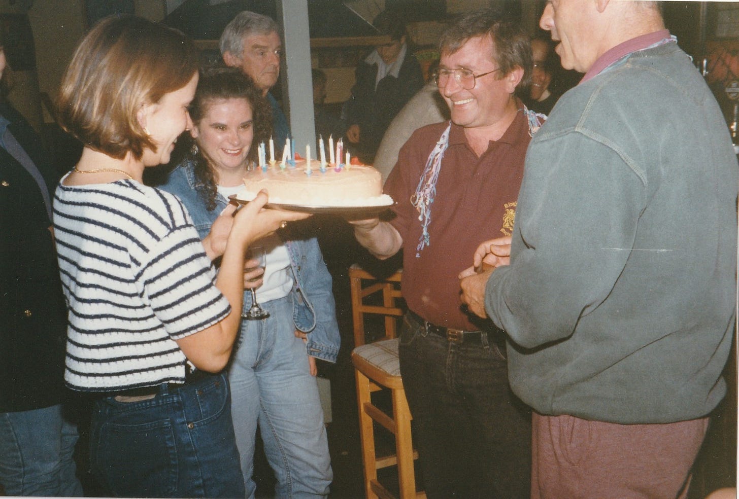 A birthday cake in the shape of boobs is presented to a man