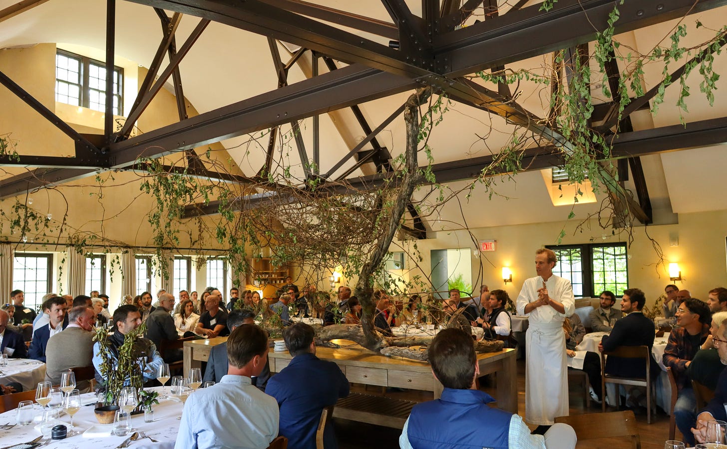 Man addressing a room of diners