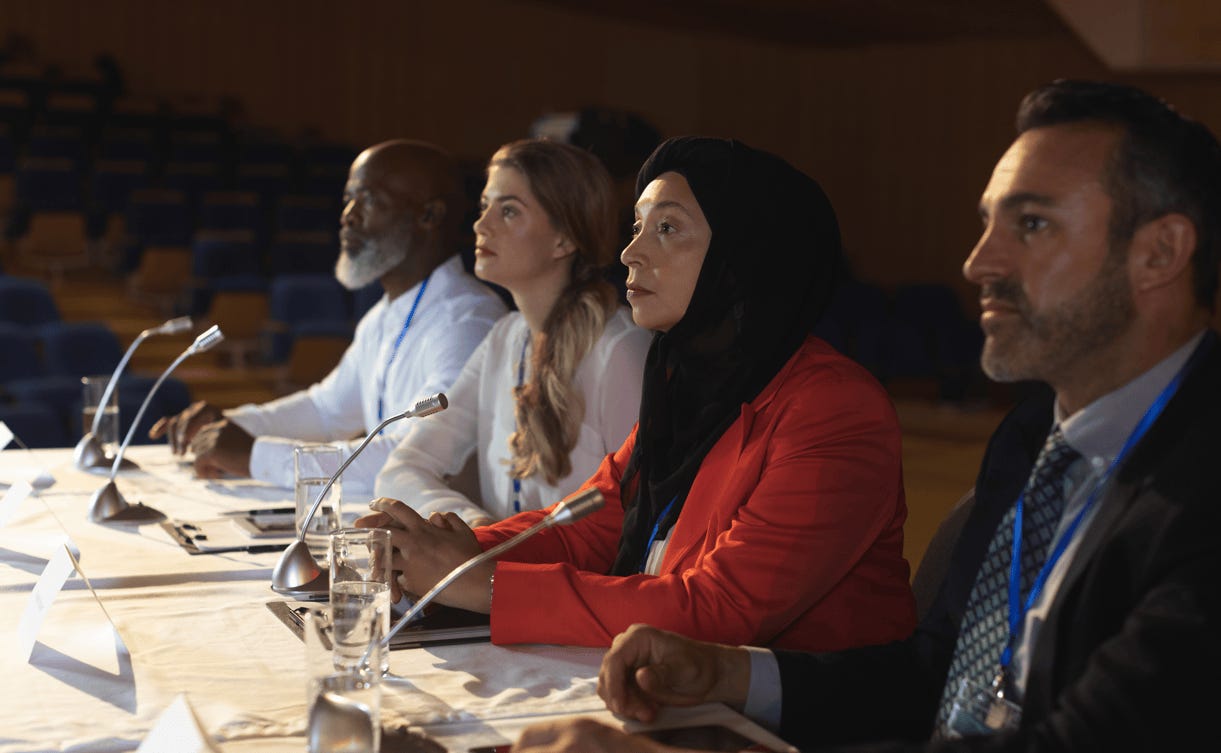 A group of people sitting at a table

Description automatically generated