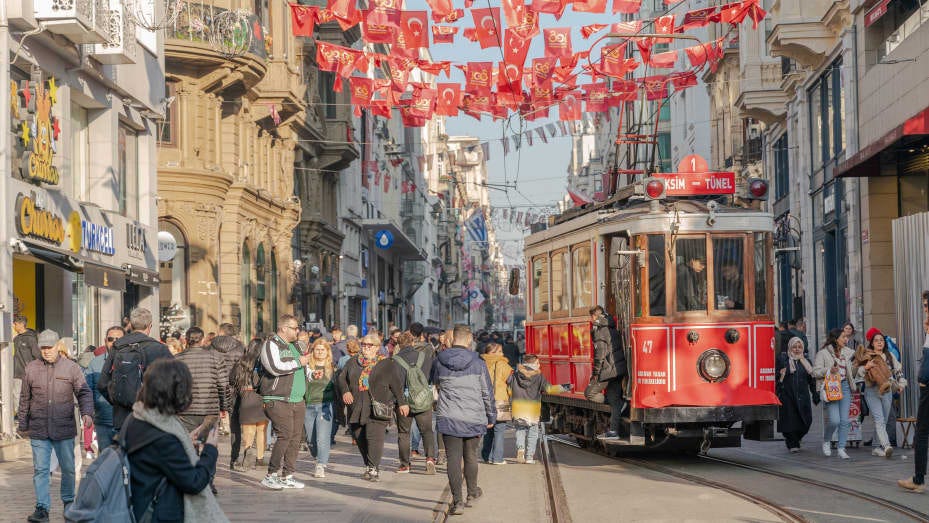 A tram passes shoppers as it travels along Istiklal Street in the Beyoglu district of Istanbul, Turkey, on Tuesday, Dec. 19, 2023.