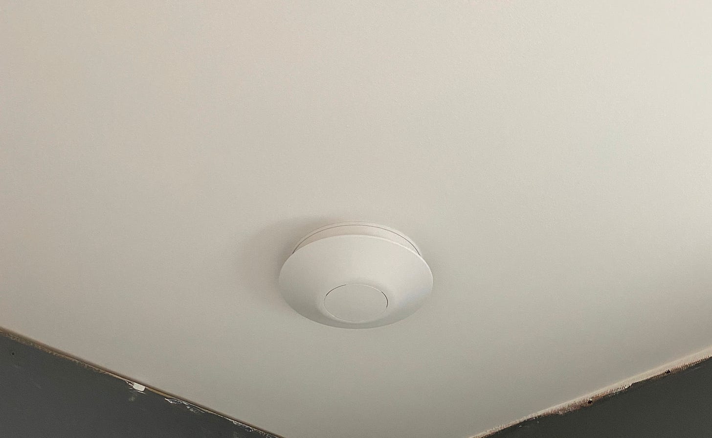 white extractor fan positioned on a white ceiling