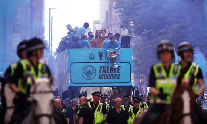 Man City celebrate winning treble of major trophies with open-top bus  parade in rain | Arab News