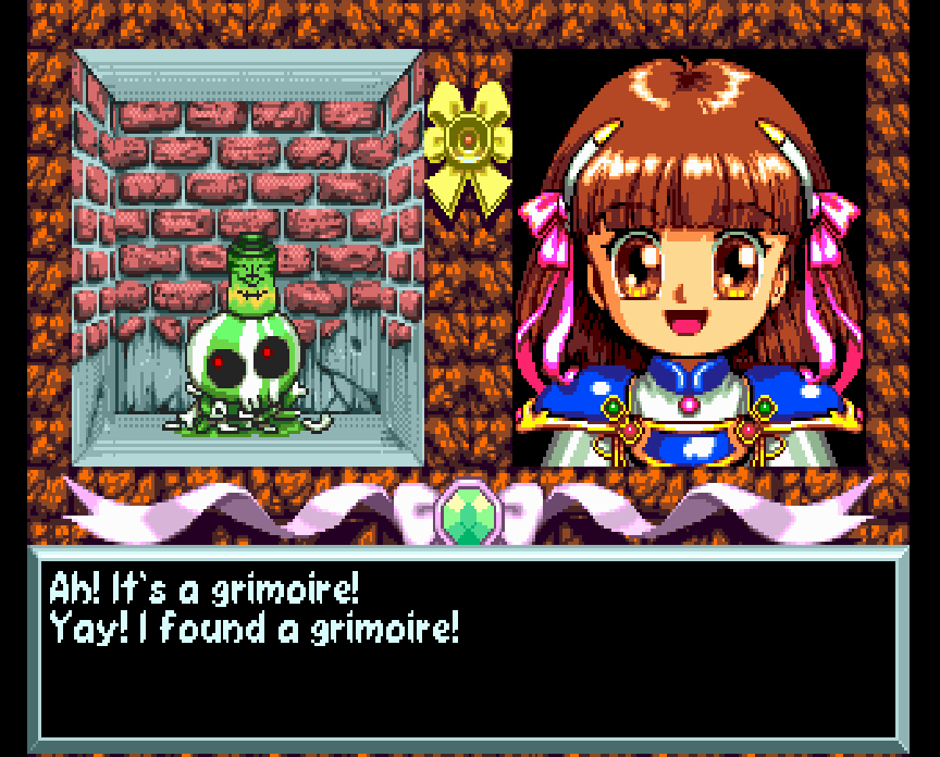 A screenshot from Madou Monogatari I: Honoo no Sotsuenji, showing an inset image of Arle on the right, excited and smiling, while on the left is a mystical object bleeding green on top of a skull on the floor. The walls are bricked up, and the dialogue box at the bottom says, "Ah! It's a grimoire! Yay! I found a grimoire!"