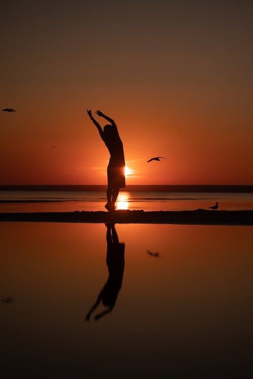 Free Silhouette of a Woman Dancing during Sunset Stock Photo