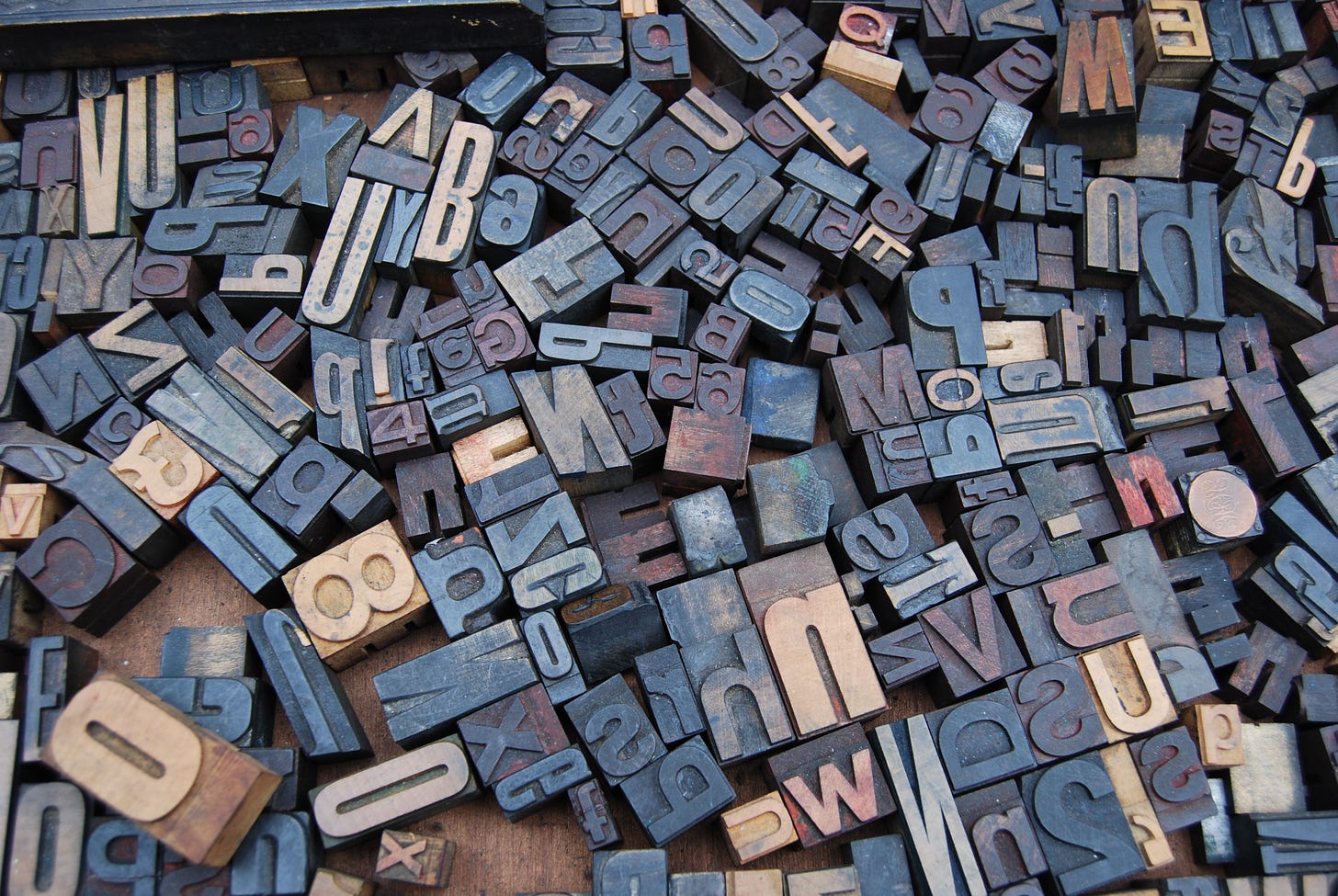 A series of typographical blocks piled together.